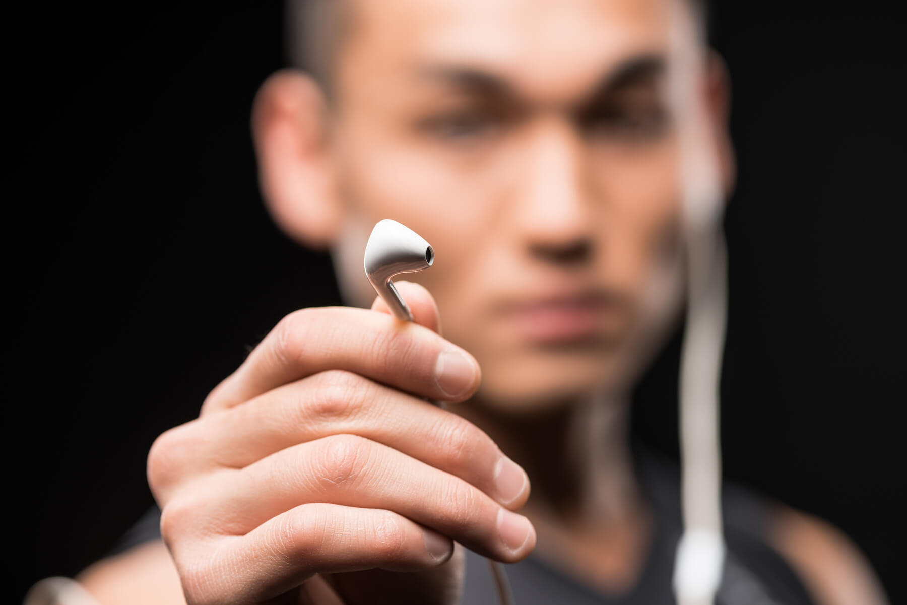 close up view of young man holding earphones isola 2023 11 27 04 55 06 utc.jpg